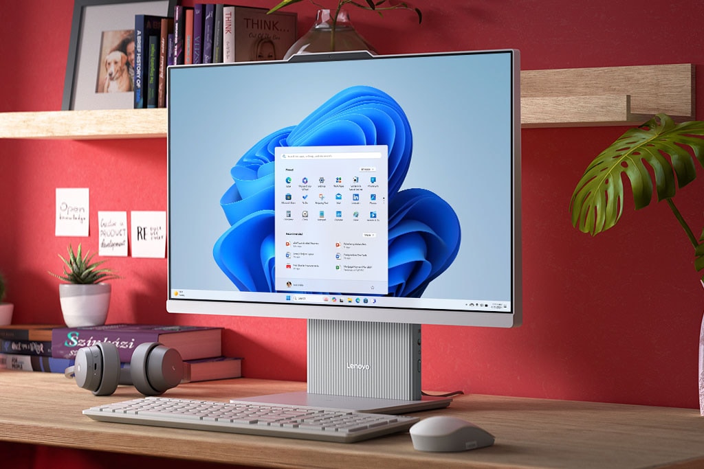 Front facing Lenovo IdeaCentre All-in-One PC on a desk, with Windows 11 Home Start menu on the display.